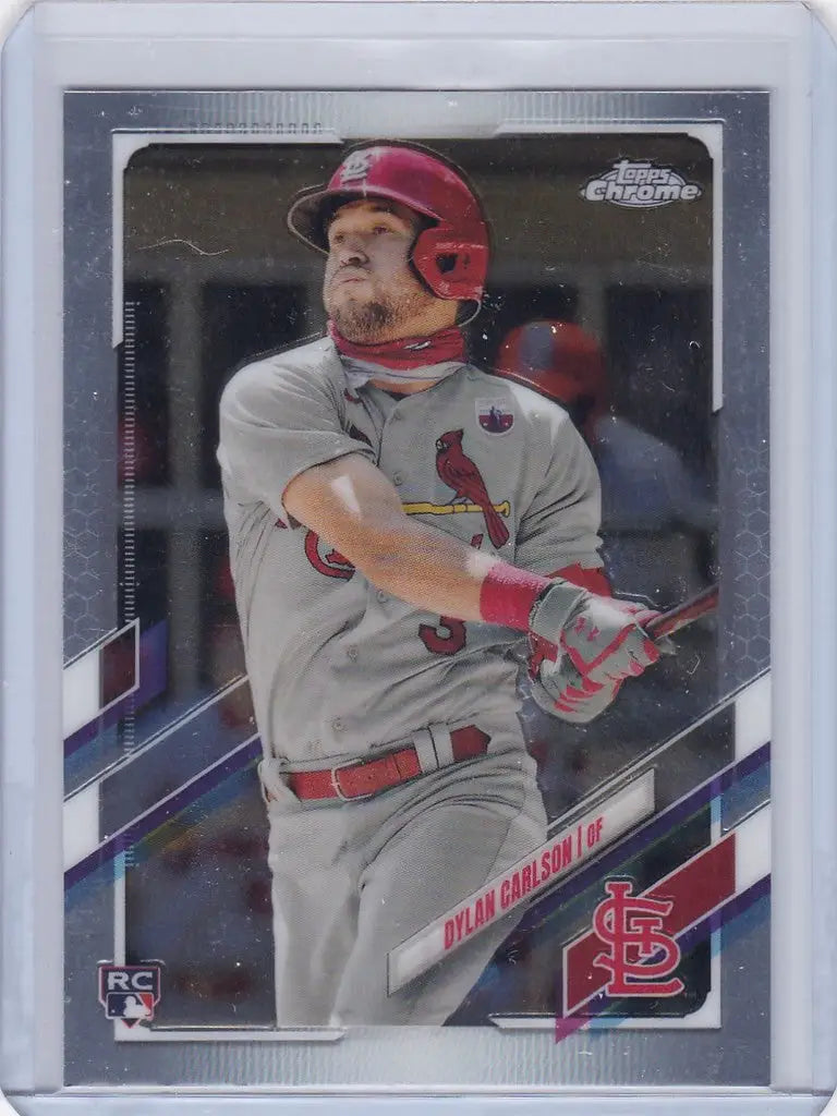 Baseball card showcasing Dylan Carlson swinging for the St. Louis Cardinals Topps Chrome