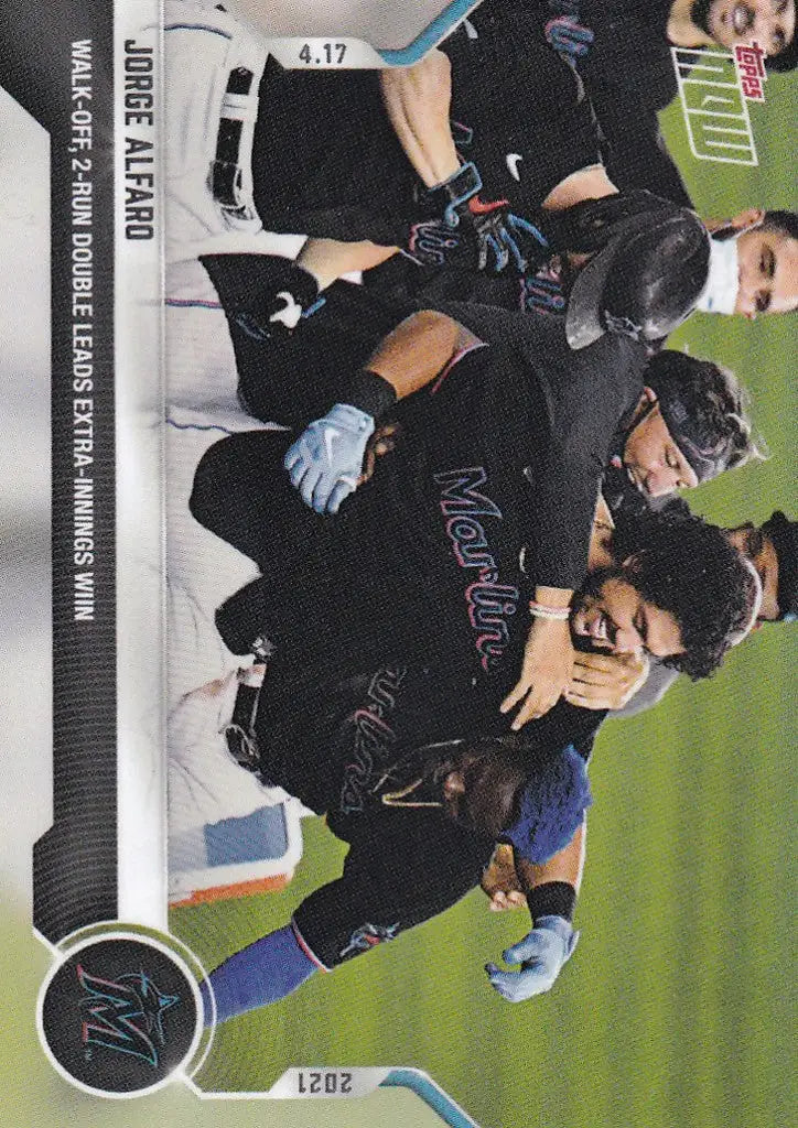 Baseball players in dark uniforms celebrating Jorge Alfaro’s Miami Marlins walk-off double