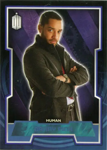 Man in a dark suit with arms crossed against a purple background blue foil parallel card