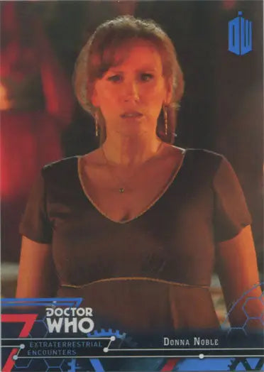 Woman with blonde hair in a black top poses with Doctor Who Blue Parallel Chase Card