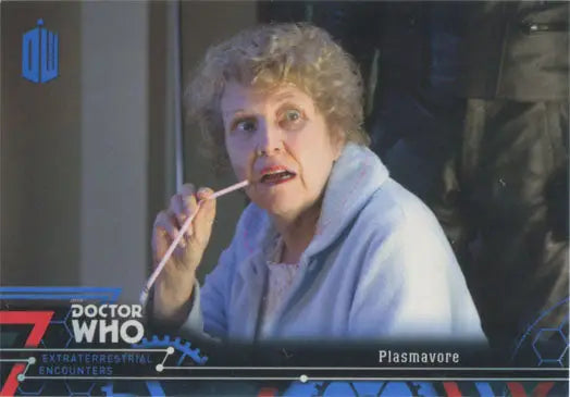 Older woman with curly gray hair in light blue sweater, showcasing Blue Parallel Chase Card