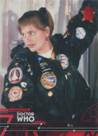 Person in colorful patch jacket displaying Doctor Who Red Parallel Chase Card 17