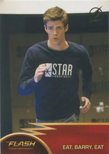 Young man in dark sweatshirt with STAR print from Flash Season 1 Gold Logo Parallel Chase Card