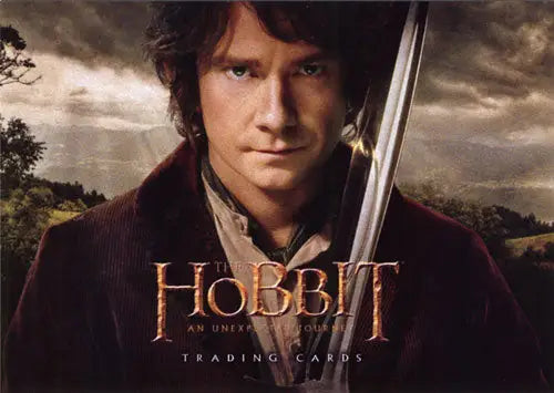 Hobbit holding a sword with dramatic sky, featured on Hobbit An Unexpected Journey promo card