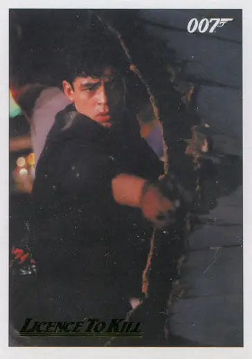 Man in dark shirt with weapon and 007 logo on James Bond Gold Parallel Chase Card