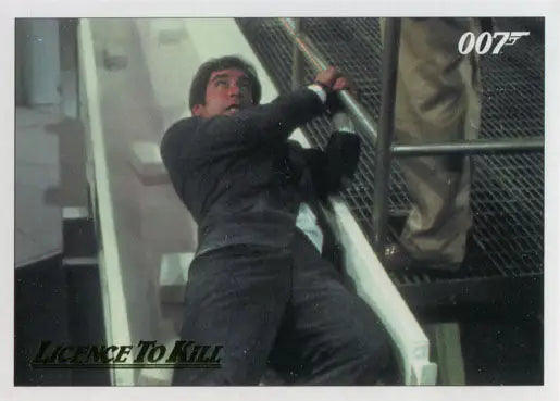 Man in a suit climbs a metal structure on James Bond 007 Gold Parallel Chase Card