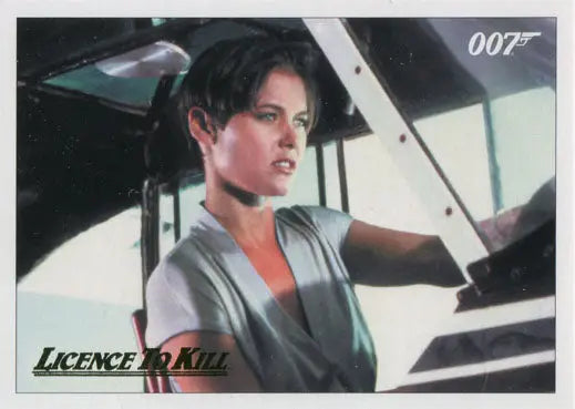 Woman in gray jacket in vehicle cockpit on James Bond 007 Gold Parallel Chase Card