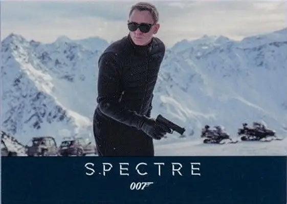 Man in dark clothing with a gun in snowy mountains on James Bond promo card