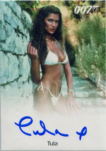 Woman in white bikini against stone wall in James Bond Archives Autograph Card