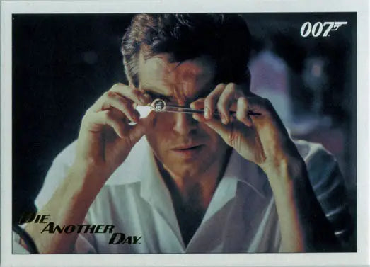 Man in a white shirt adjusting glasses on James Bond Archives Gold Foil Trading Card