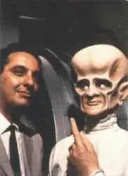 Man in a suit beside alien figure featured on Outer Limits Duo Cards promo card