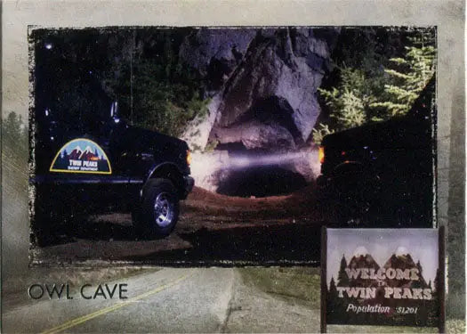 Illuminated cave entrance resembling owl’s face with vehicle, featured in Twin Peaks trading cards