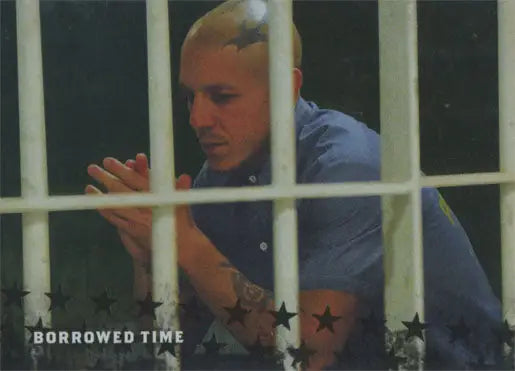 Man in a blue shirt behind prison bars featured on Sons of Anarchy trading card