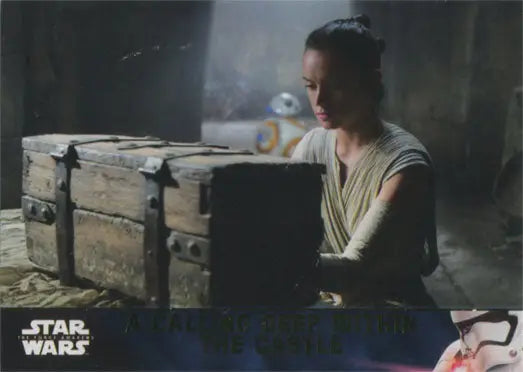 Young woman in light clothing examines Star Wars trading cards gold parallel box