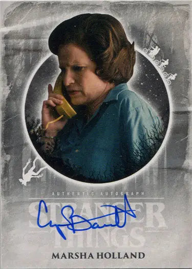Cynthia Barrett speaking on a green telephone in a blue shirt for trading cards