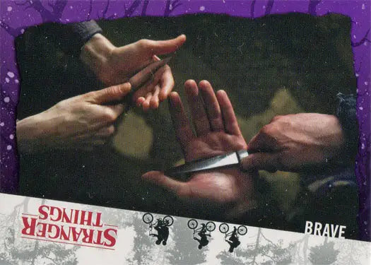 Hands interacting with each other on a dark background highlighting a purple parallel trading card