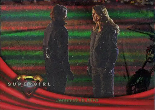 Two people face each other in a dimly lit scene with colorful rainbow foil background