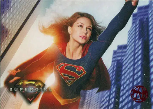 Supergirl in blue suit and red cape flying over city, featured on Red Omegahedron Deco card