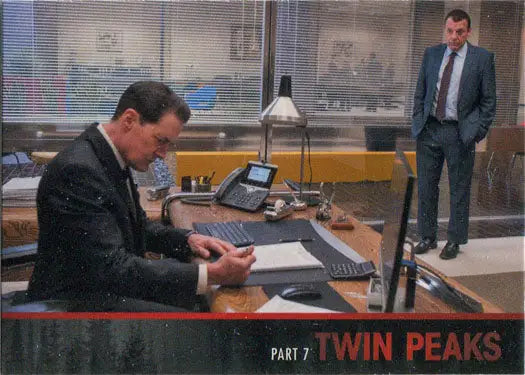 Two men in suits discuss a Limited Series Event in a stylish office setting
