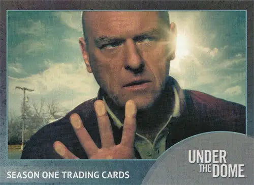 Close-up portrait of a stern man on Under the Dome Promo Card from SDCC 2014