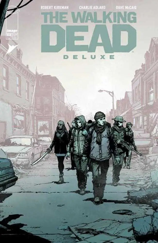 Comic book cover for Walking Dead Deluxe showing survivors on a deserted street