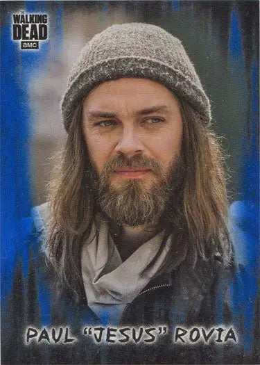 Portrait of a bearded man in a knit cap and scarf on a Walking Dead blue parallel card