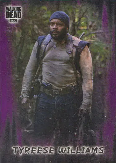 Man in beanie and backpack in forest with Walking Dead Hunters Hunted Purple Parallel Card