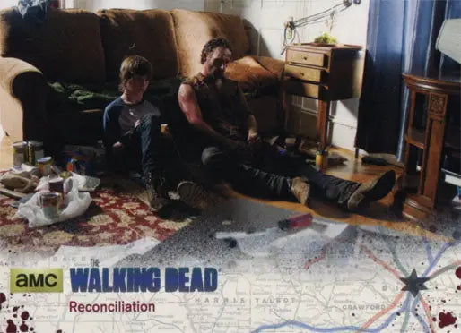 Two people on a couch in a messy room from The Walking Dead Silver Parallel trading card