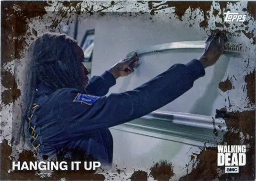 Person in blue hoodie writing on whiteboard near Walking Dead Mud Parallel Base Card