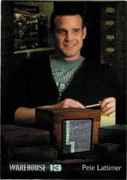 Man in dark jacket and green shirt holding a device from Pete Lattimer trading card