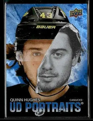 Black bauer hockey helmet with the number 43 and a split-face design featuring quinn hughes.