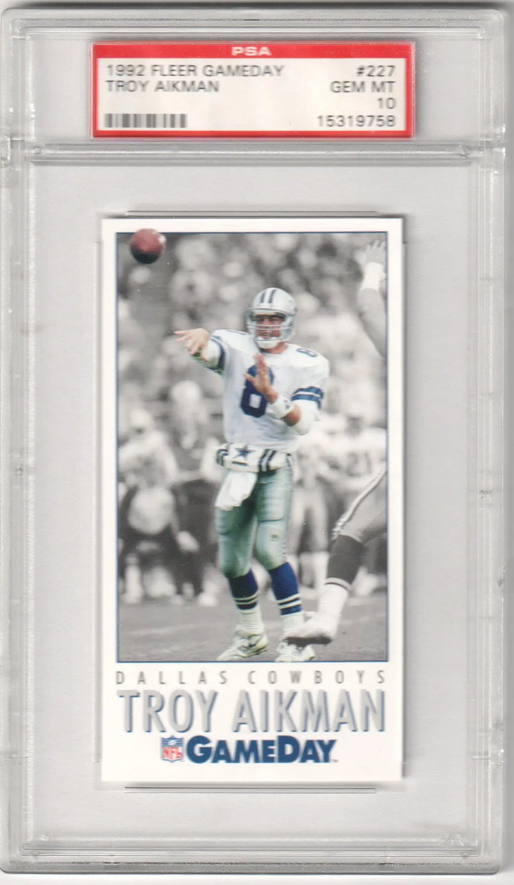 1992 fleer gameday troy aikman trading card, graded psa 10 by the dallas cowboys quarterback in a black-and-white action shot with his number 8 jersey and helmet.