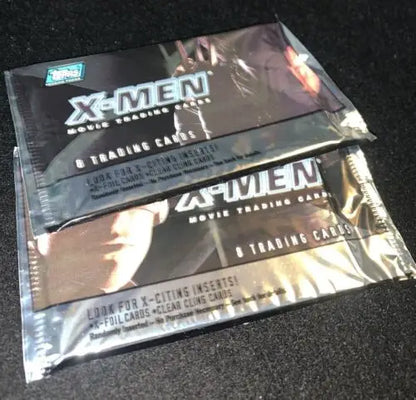 Two sealed packs of 2000 Topps X-Men movie trading cards showcasing Marvel Comics characters
