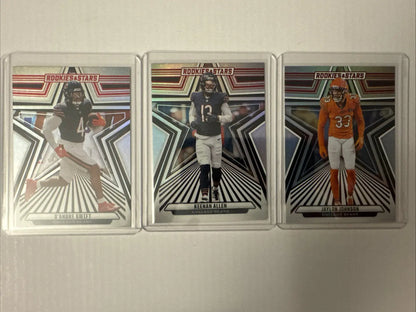 Three Chicago Bears rookie football cards featuring William Perry and Devin Hester in protective sleeves