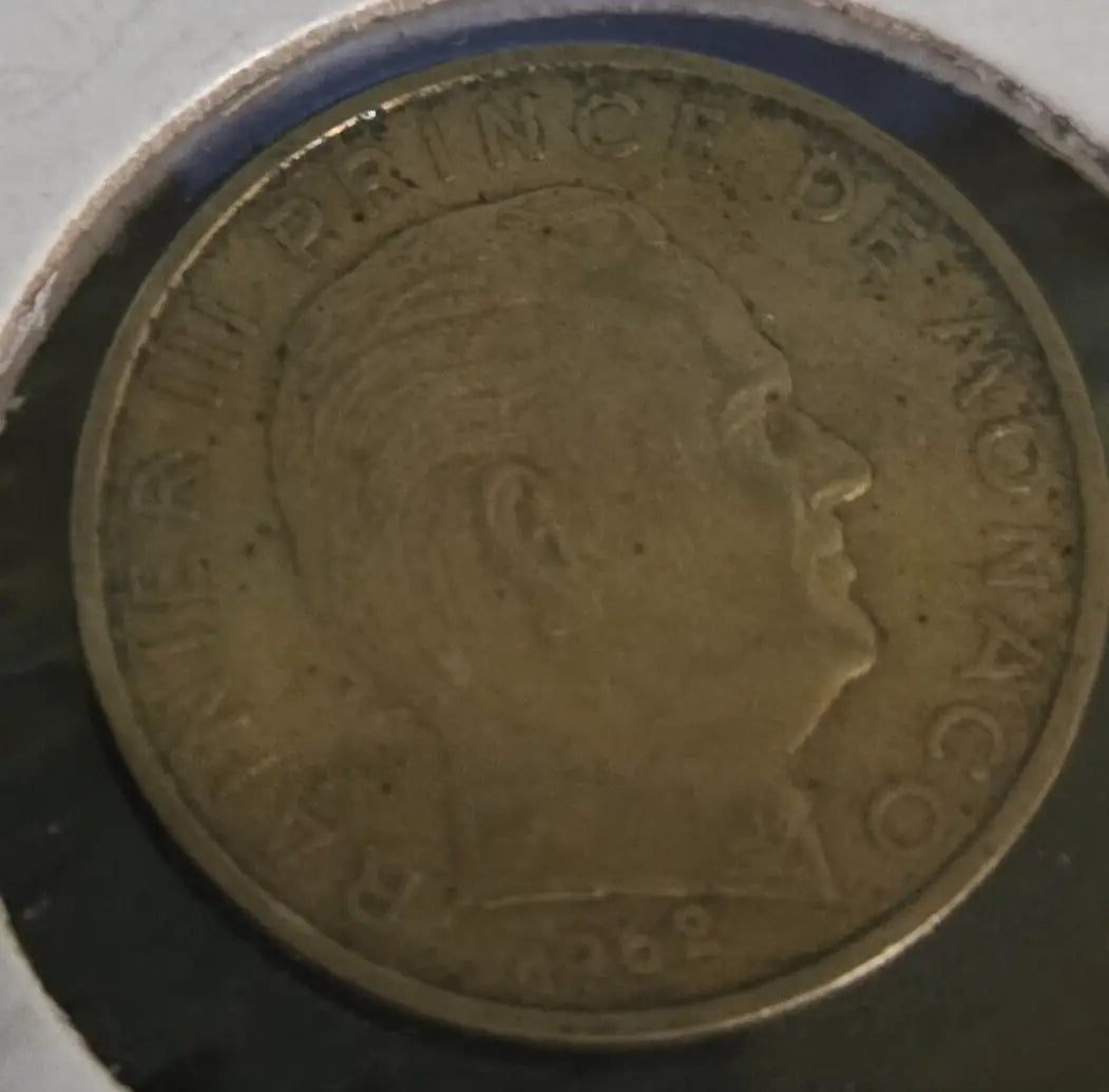 Worn Monaco 1962 20 centimes coin with profile portrait displayed