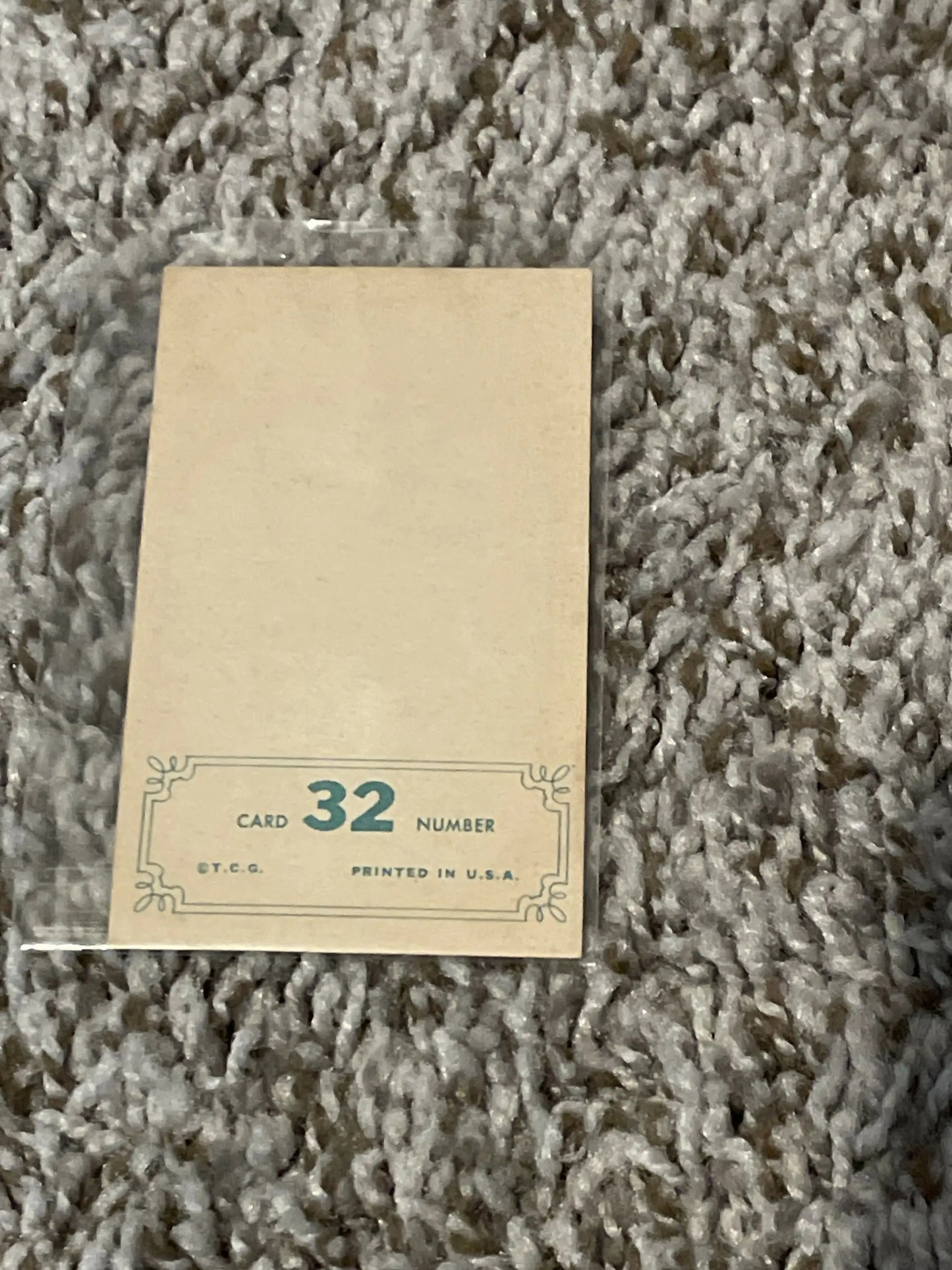 Vintage numbered card 32 from 1965 Topps embossed baseball cards on textured surface