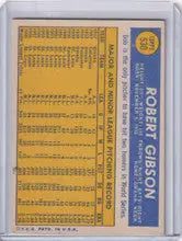 Topps Baseball card of Bob Gibson with player stats on a yellow background