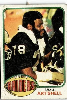 1976 Topps Art Shell football card featuring Oakland Raiders player on display