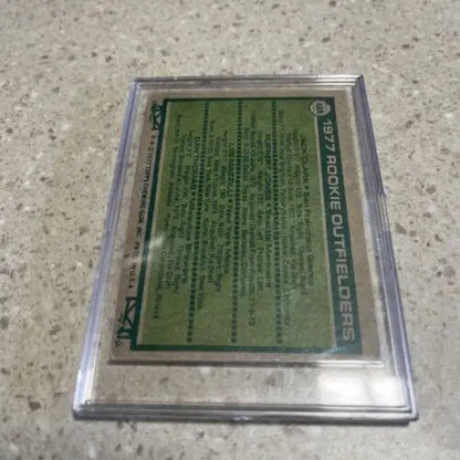Encased 1977 Topps trading card featuring rookie outfielders Jack Clark, Lee Mazzilli