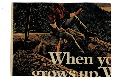 Image of a person in a plaid shirt and jeans sitting on rocks for Mike Barber Houston football card