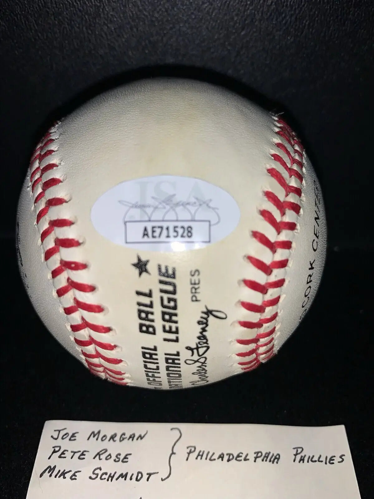 White baseball with red stitching and authentication sticker featuring Philadelphia Phillies, Pete Rose, Mike Schmidt