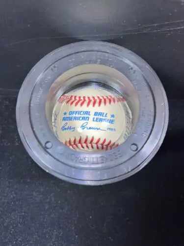 Baseball in gray holder showcasing 1985 Timers Game signatures and baseball cards