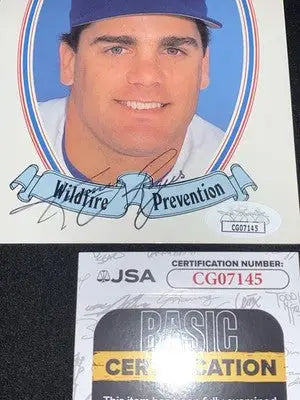Autographed baseball card of Kenny Rogers in a blue hat featuring Texas Rangers logo