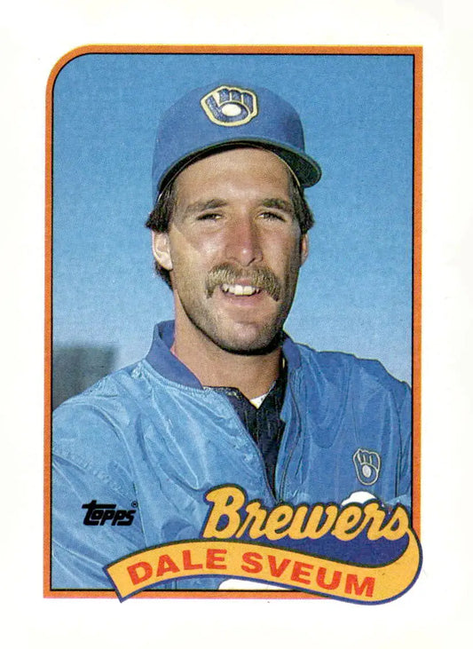 Baseball card of Dale Sveum with mustache, blue cap, and jacket from 1989 Topps