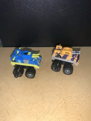 Two Micro Machines toy monster trucks from the 1991 Galoob MICRO MACHINES Wind-Up CRANKERS Tank Lot