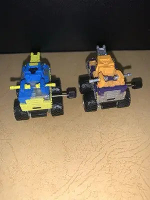 Two toy micro machines monster trucks from the 1991 Galoob MICRO MACHINES Wind-Up CRANKERS Tank Lot