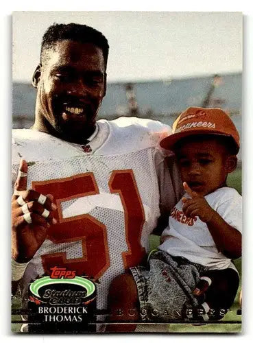 Vintage American football trading card featuring Broderick Thomas Tampa Bay Buccaneers with child