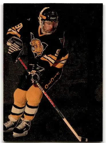 Classic Four Sport image of hockey player in black and gold tiger uniform holding a stick