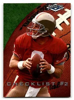 Steve Young holding a football from Classic Assets trading cards 1994-95