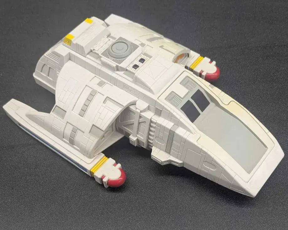 White toy spaceship model with red and yellow accents from the 1994 Playmates Star Trek Runabout Orinoco